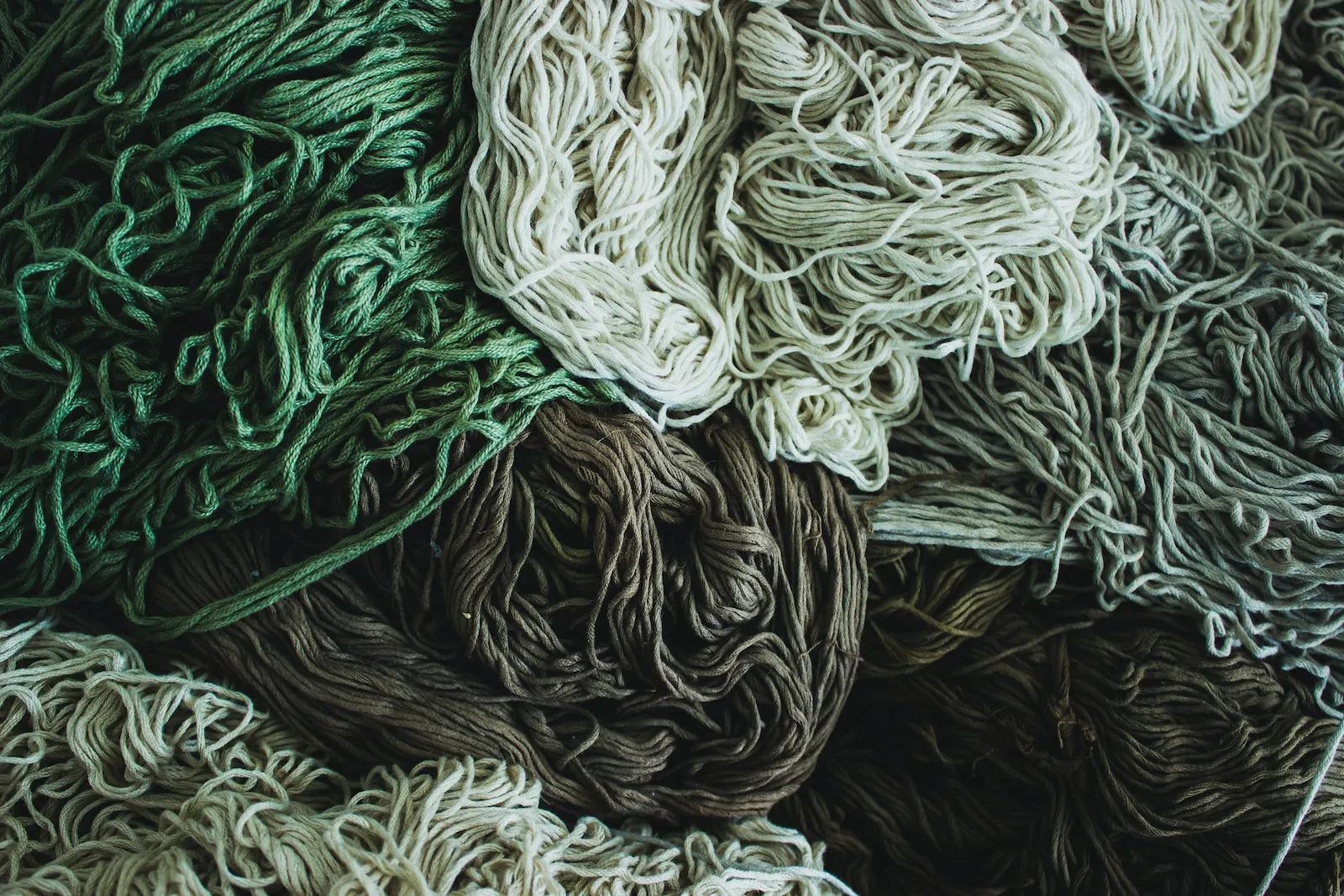 pile of white, gray, and green ropes
